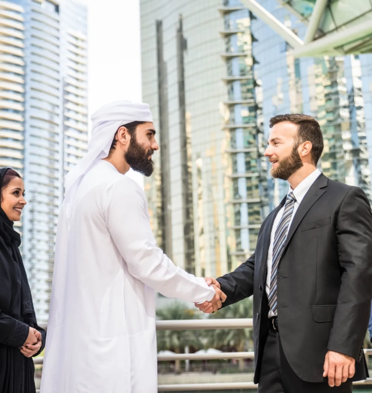 Business professionals shaking hands in an urban setting